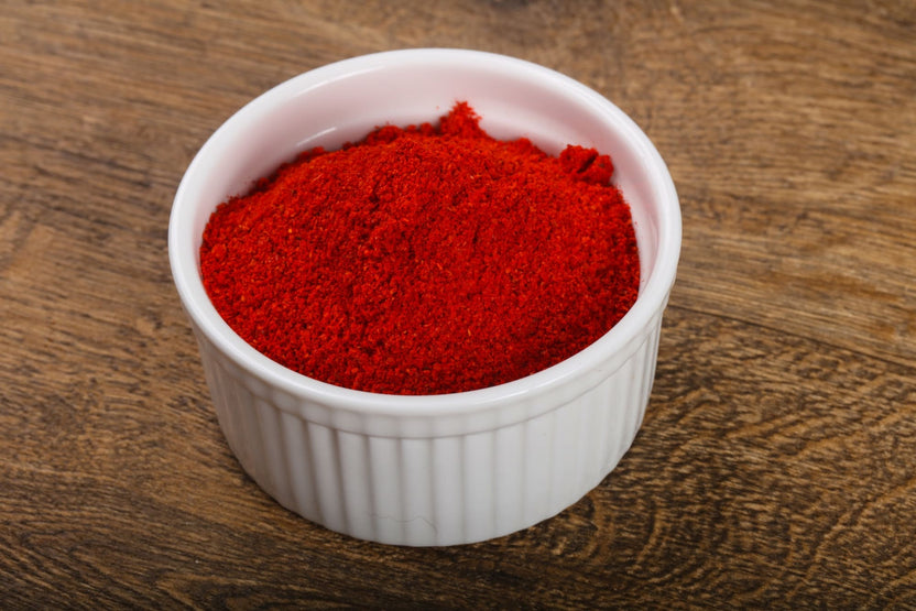 White bowl filled with b12 powder on a wooden surface